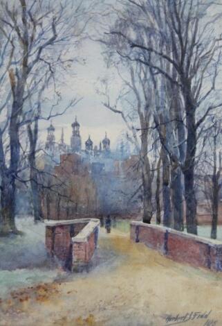 Herbert John Finn (1860-1942). Figure on a tree lined path before spires