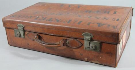 An early 20thC tan leather travelling case