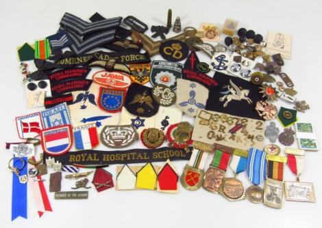 Various war related metal iron on and other badges