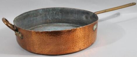 An early 20thC copper and brass pan