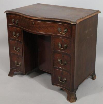 A George III mahogany serpentine fronted kneehole dressing table