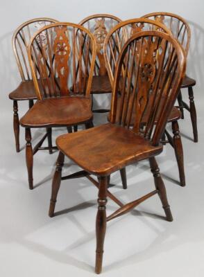 A harlequin set of six late 19thC ash and elm wheel back kitchen chairs