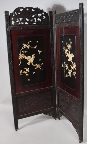 An early 20thC hardwood Oriental design two fold screen