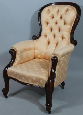 A Victorian mahogany spoon back open armed chair