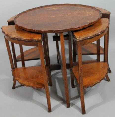 A 1930's walnut veneered occasional table set