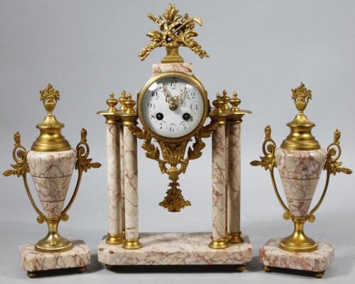 A late 19thC gilt metal and pink marble clock garniture