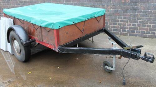 A wooden framed car trailer