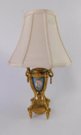 A French late 19thC gilt metal and porcelain table lamp