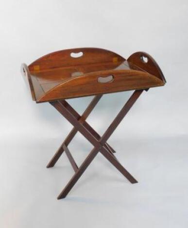 A mahogany tray top butler's table