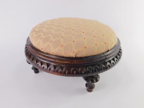 A Victorian carved circular oak foot stool