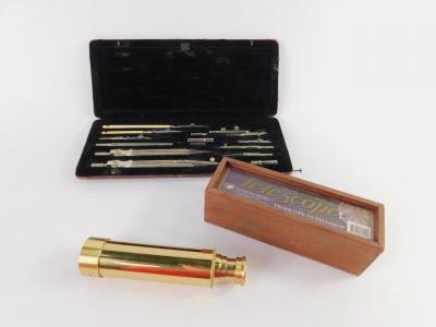 A set of early 20thC steel and ivory technical drawing instruments, leather cased, and an Authentic Models brass three draw telescope, boxed.