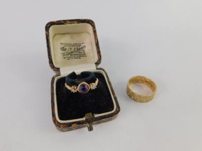 An amethyst and diamond three stone ring