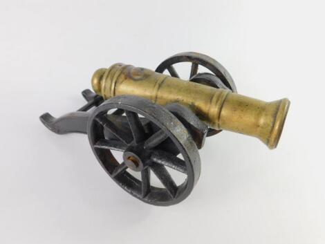 A brass and cast iron table cannon