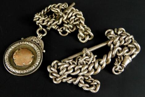 A silver watch chain and fob