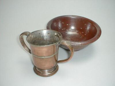 An Old Sheffield plate loving cup by Oldham and a stoneware strainer bowl