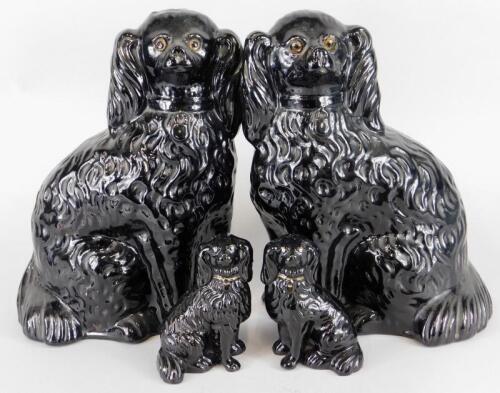 Two pairs of 19thC black glazed terracotta spaniels