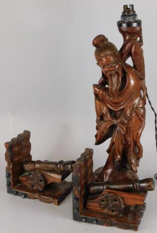 An oriental carved hardwood figure of a fisherman