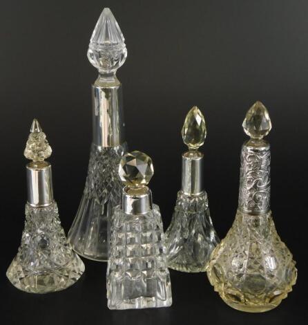 A collection of five cut glass scent bottles and stoppers