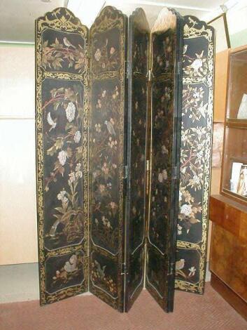 A Japanese black lacquer four fold coromandel dressing screen with gilt