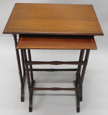 A pair of Edwardian mahogany and satinwood cross banded tables