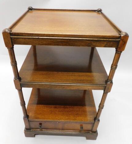 A mahogany three tier whatnot in George III style