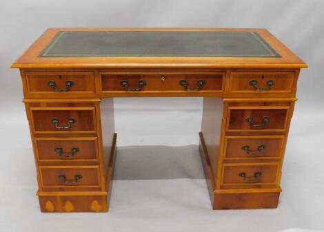 A yew veneered pedestal desk