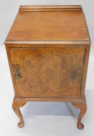 A walnut veneered bedside cabinet