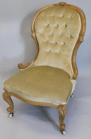 A Victorian walnut spoon back nursing chair