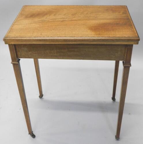 An Edwardian mahogany and marquetry card table