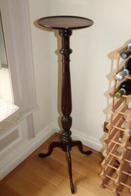 A mahogany torchere stand.