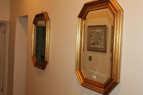 A pair of octagonal gilt framed wall mirrors with bevelled plates