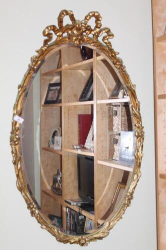 A reproduction oval wall mirror