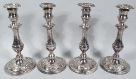 A set of four 19thC George I style Old Sheffield plate candlesticks