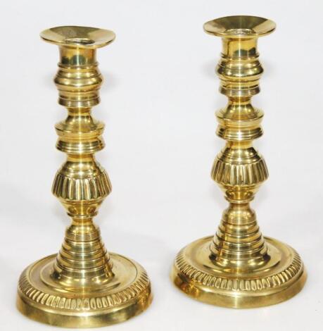 A pair of 19thC brass candlesticks