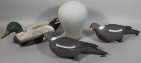 Two plastic decoy pigeons and a decoy duck