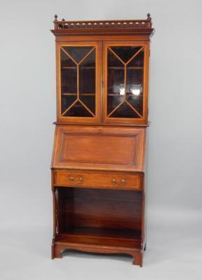 An early 20thC inlaid mahogany Sheraton Revival bureau bookcase