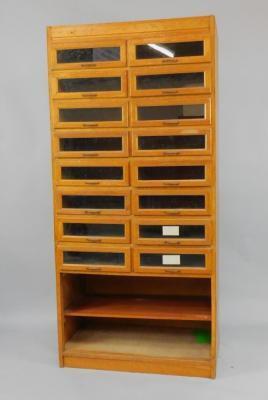 An early 20thC oak haberdashery cabinet