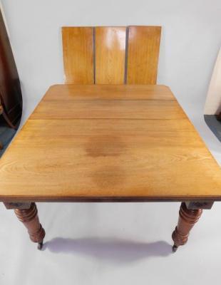 A Victorian walnut and mahogany extending dining table