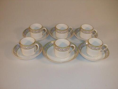 A set of six Wedgwood cream ware coffee cans and saucers