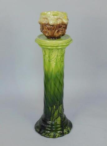 A Victorian green glazed spiral fluted jardiniere stand