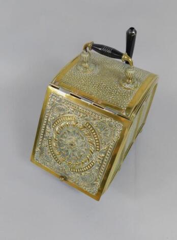 A Victorian brass coal box with embossed decoration