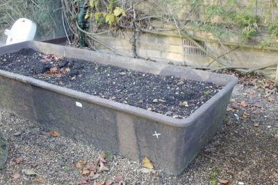 A rectangular cast iron trough