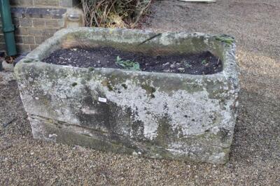 A hand hewn rectangular stone trough