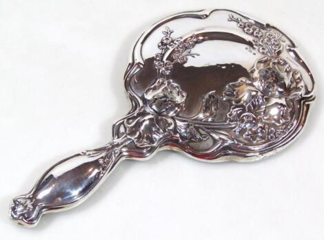 An Edwardian Art Nouveau silver hand mirror