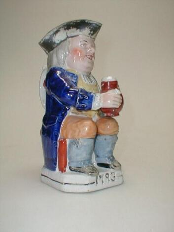 A Staffordshire Toby Jug depicting The Squire with ale and glass and marked 1793 to base