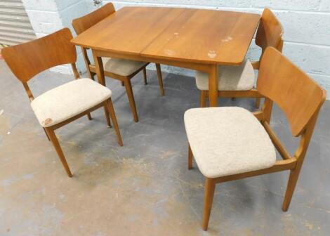 A retro style 1970's teak extending dining table and four chairs.