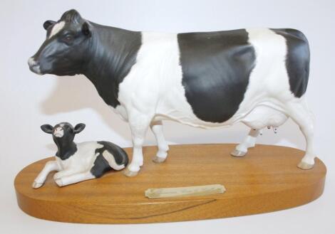 A Royal Doulton Friesian cow and calf figure group