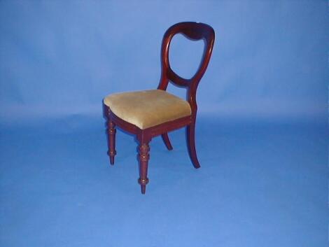 A set of four Victorian mahogany balloon back dining chairs with drop in