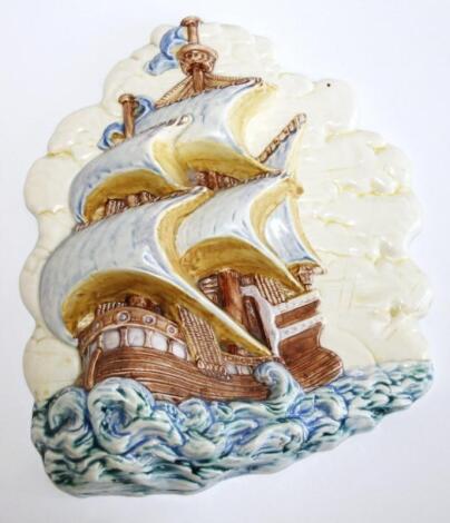 A relief pottery plaque of a galleon