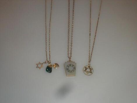 Three assorted pendants on chain